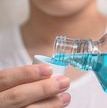 Hand of man Pouring Bottle Of Mouthwash Into Cap.jpg