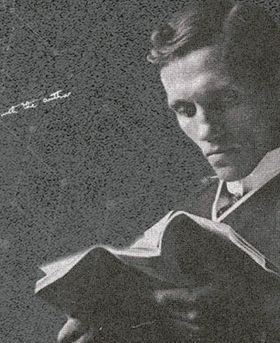 Black and white photo of young Alexander Fleming reading a book.